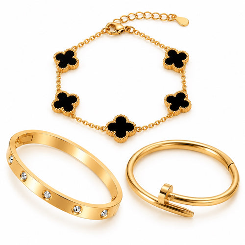 Three gold-plated bracelets in black clover, crystal bangle and nail-inspired designs on white background