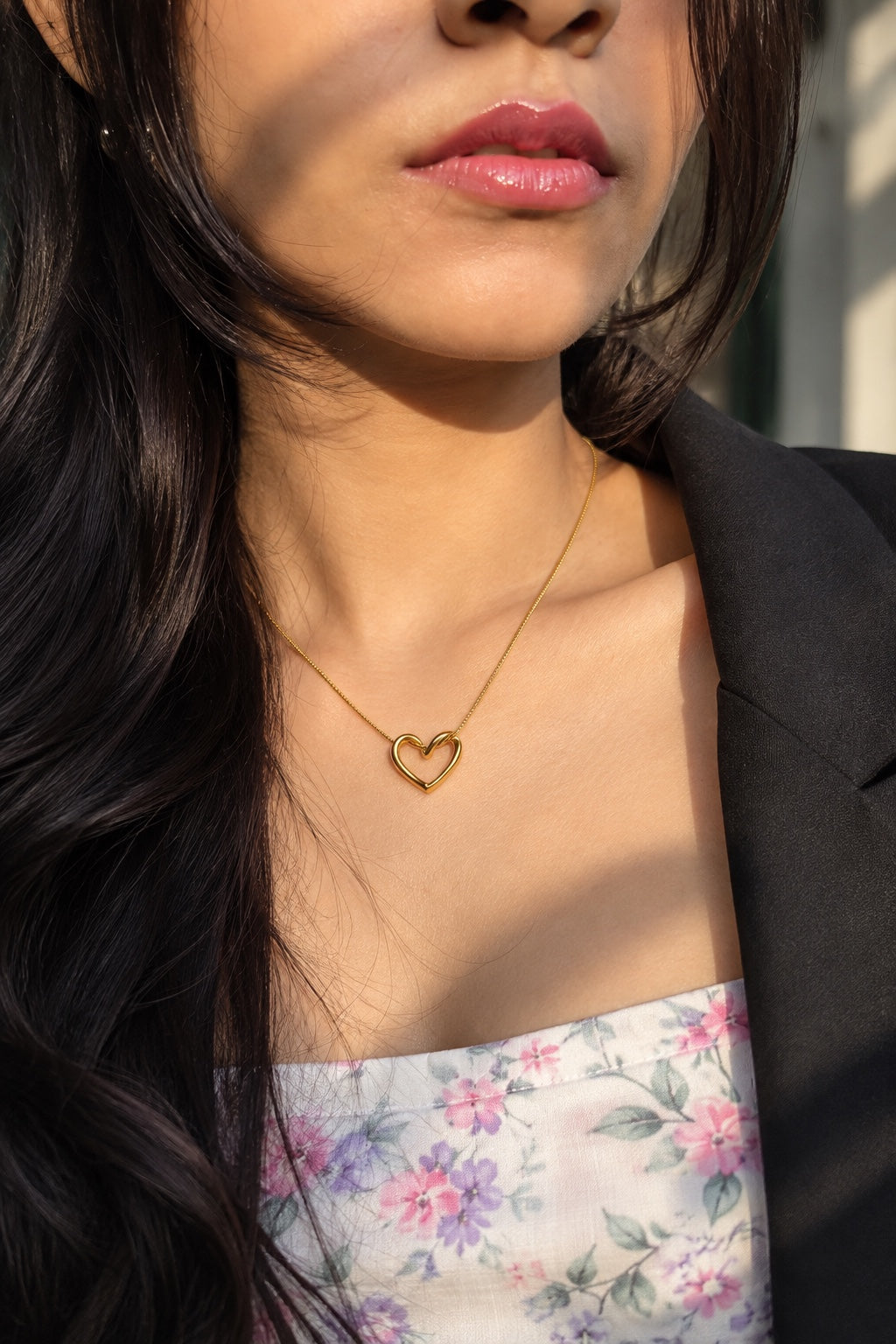 Gold-plated open heart pendant necklace worn around the neck