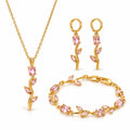 Gold-plated pink floral necklace, earrings and bracelet set on white background